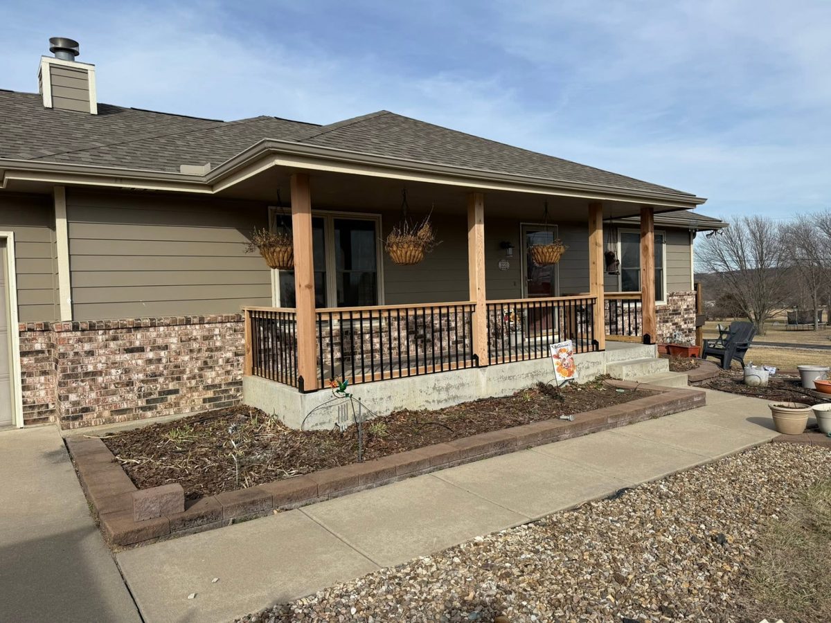 Front porch after installation of new handrails and roof-support posts